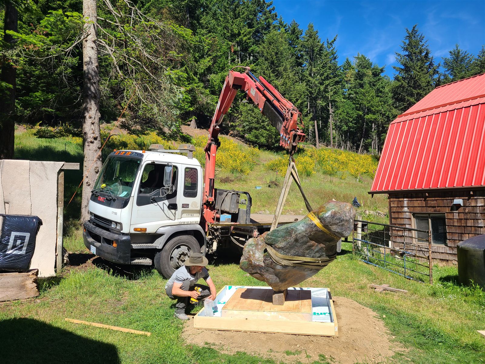 Crane placing a large stone